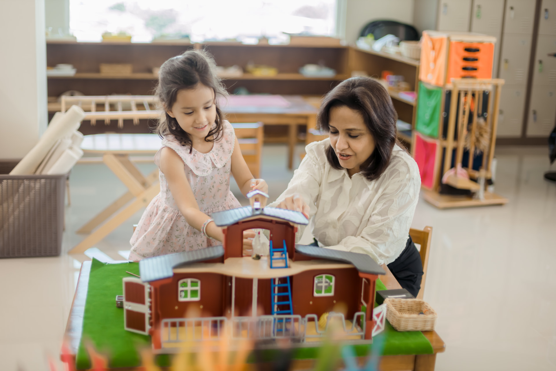 Montessori educator working with children in an Early Childhood classroom