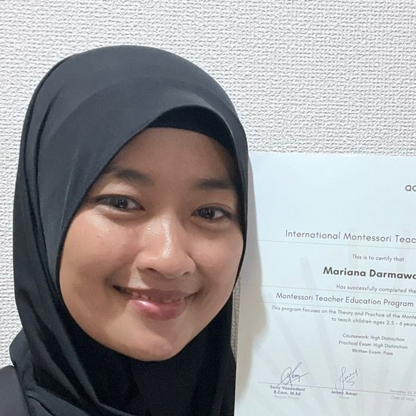 Mariana Darmawanti, Academy of Montessori graduate holding her International Montessori Teaching Diploma