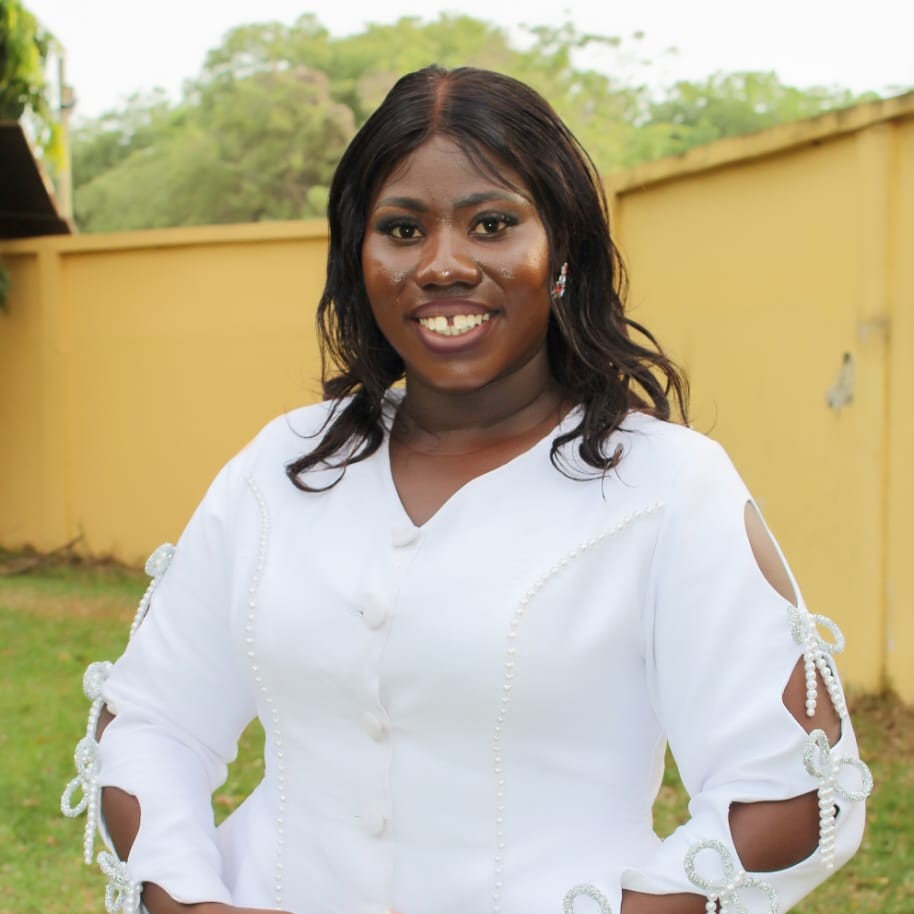 Bridget Asomani, Academy of Montessori graduate holding her International Montessori Teaching Diploma
