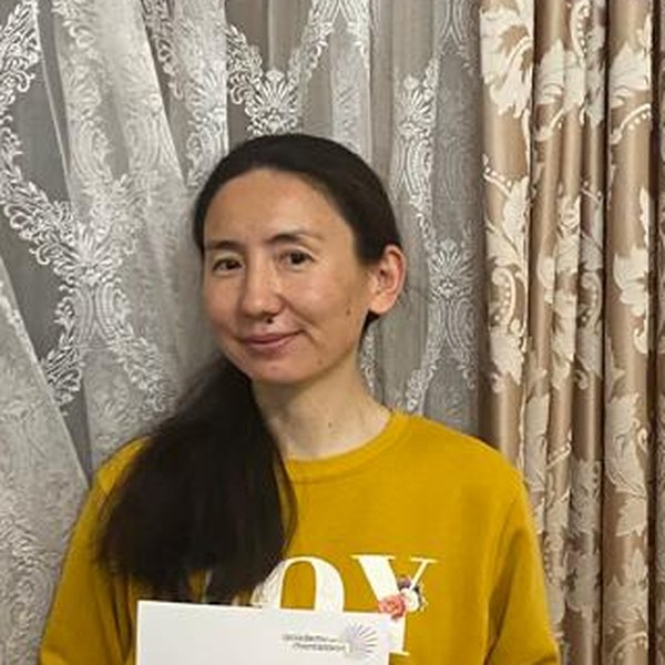 Zhanar Nagayeva, Academy of Montessori graduate holding her International Montessori Teaching Diploma