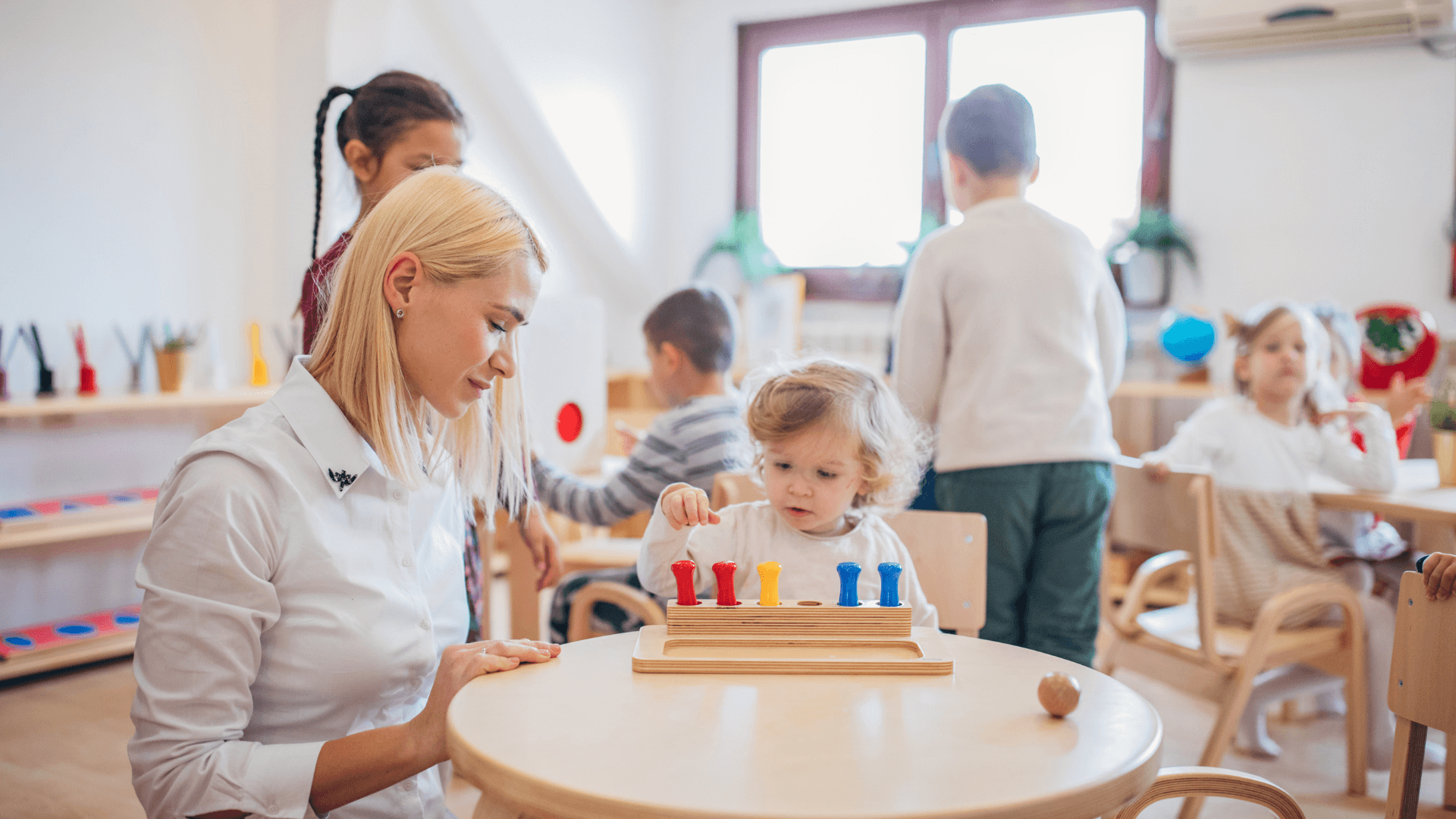 Montessori Teacher Allowing Independent Exploration
