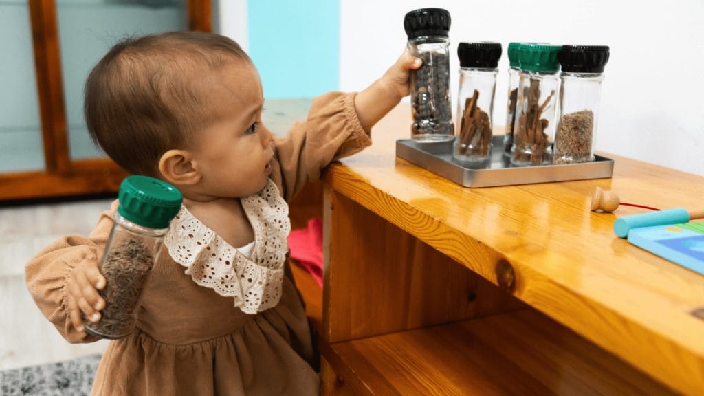A child grabbing materials from a shelf in a Montessori classroom
